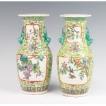 A pair of yellow ground modern Chinese vases decorated with panels of grapes and vines and with lion