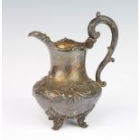 A William IV silver cream jug with scroll decoration on scroll feet, London 1833, 334 grams