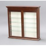 A 19th Century style mahogany display cabinet with moulded cornice and shelved interior enclosed