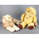 A yellow Steiff bear 84cm (pads have been replaced, the ear stud is missing) together with a lion