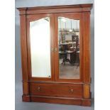 An Edwardian inlaid mahogany double wardrobe with moulded cornice enclosed by a pair of arched