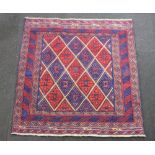 A red and blue ground Gazak rug with all over geometric design 125cm x 123cm