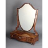 A 19th Century shield shaped dressing table mirror contained in a mahogany frame, base of serpentine