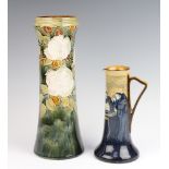 A Doulton series ware jug 20cm together with a Royal Doulton waisted vase decorated with flowers