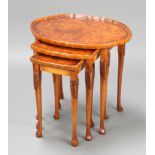 A nest of 3 Queen Anne style oval figured walnut interfitting coffee tables, raised on cabriole