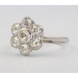 A platinum and diamond 7 stone cluster ring, size O, 1.5ct, 5.2 grams