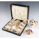 A porcelain polychrome and gilt floral coffee set comprising 6 coffee cans and saucers with plated