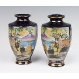 A pair of early 20th Century Japanese blue ground Satsuma vases decorated with figures before
