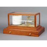R R Lucking, Hampton Court, a battery operated barograph contained in a mahogany case, the base