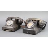 A black Bakelite dial telephone the base marked 332L Pl57/2A and 1 other dial telephone marked