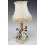 A modern Dresden table lamp in the form of a 4 figures dancing round a tree 24cm