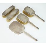 A silver engine turned 5 piece dressing table set comprising 2 hand mirrors, 2 clothes brushes, 1