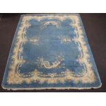 A 1930's blue ground Chinese carpet decorated fabulous birds 361cm x 279cm Some flecking in