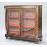 A Victorian ebonised and figured walnut display cabinet, fitted shelves and having gilt metal mounts