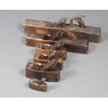 Two wooden shooting/jack planes together with 4 smoothing planes