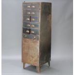 A mid Century industrial 10 section metal locker, the base fitted a cupboard enclosed by a flap