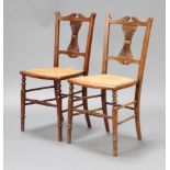 A pair of Victorian walnut bar back bedroom chairs with pierced vase shaped slat backs, woven cane