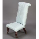 A Victorian prie dieu chair upholstered in blue material raised on castors (1 f)