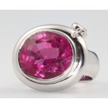 An 18ct white gold oval pink tourmaline ring with drop diamond, centre stone approx. 18ct, the