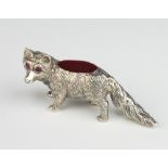 A modern Sterling silver pin cushion in the form of a standing fox with gem set eyes, gross weight