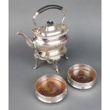 A silver plated tea kettle and stand with burner and a pair of coasters