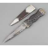 A Scottish dirk with 10cm blade contained in a leather and silver mounted scabbard by Henry Tatton