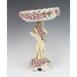 A German porcelain Dresden style centrepiece with a pierced basket decorated with roses, raised on a