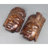A pair of Bali carved hardwood masks 30cm x 18cm