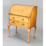 A Queen Anne style figured walnut bureau, the fall front revealing a well fitted interior above 2