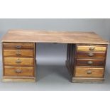 A Victorian mahogany partners desk fitted 16 short drawers with oval metal handles, raised on a