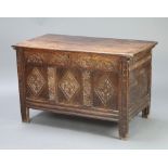 A 17th/18th Century carved oak coffer of panelled construction with hinged lid and iron lock 68cm