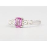 An 18ct white gold pink sapphire and diamond ring, centre stone approx. 0.45ct, princess cut diamond