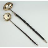 A Georgian silver punch ladle with coin set base and whalebone handle, a plain ditto