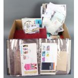 A box containing an album of mint and used world stamps, a small album of first day covers,