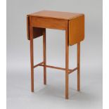 An Edwardian mahogany drop flap occasional table raised on square tapered supports with H framed
