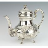 A Continental 800 standard silver baluster repousse teapot with S scroll handle and floral