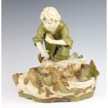 A Royal Dux centrepiece in the form of a boy crouching above a fish pond no.576 30cm There are