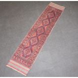A red and blue ground Meshwani runner with 5 diamonds to the centre within a multi row border