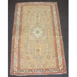 A Caucasian style rug with stylised medallion to the centre within a multi row border 218cm x