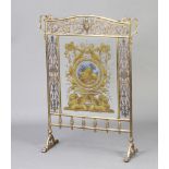 A Victorian pierced gilt metal etched and painted glass firescreen, the panel to the centre