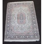 A white and blue silk Kashmir rug with central lozenge within a multi row border 187cm x 124cm