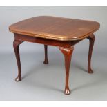 A 1930's Queen Anne style mahogany draw leaf dining table with patented draw leaf action, raised