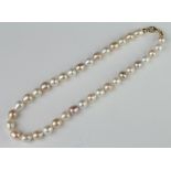 A string of 2 colour cultured pearls with an 18ct yellow gold clasp 42cm