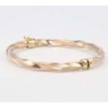 A 9ct yellow gold twist bangle, 7.4 grams