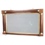 A William IV rectangular plate mirror contained in a rosewood frame with column decoration, raised