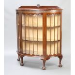 A 1930's Chippendale style mahogany bow front display cabinet with raised back, fitted shelves