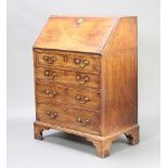A Georgian mahogany bureau, the fall front revealing well fitted interior with secret drawer,