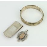 A silver money clip, bangle and fob 44 grams