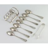 A silver Art Deco style 5 bar toast rack, London 1950, 7 teaspoons and pair of tongs, 169 grams