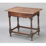 An 18th Century oak side table fitted a frieze drawer, raised on turned and block supports with